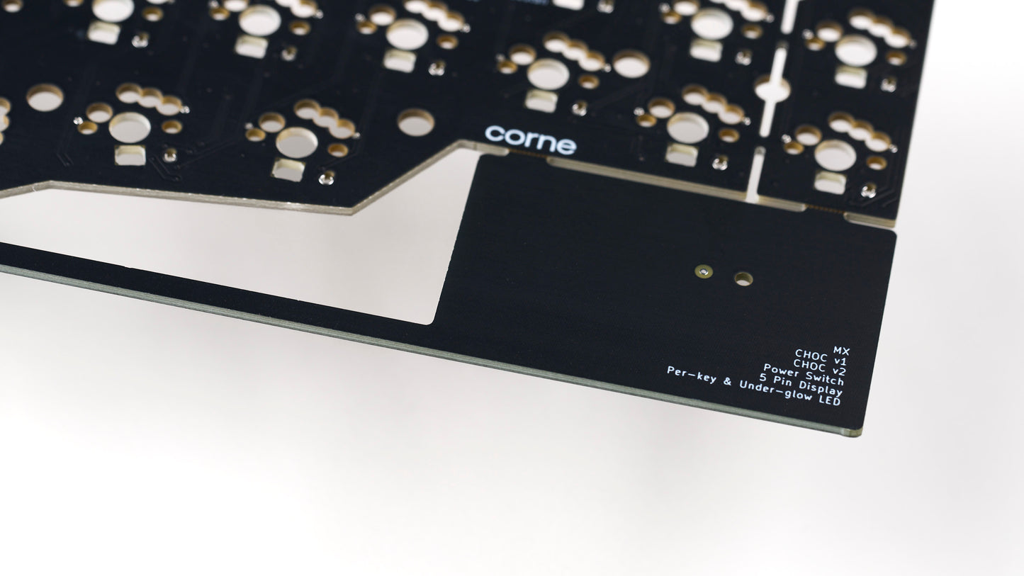 Detail view of Corne v3.6 PCB breakaway tab with printed feature list and corne logo