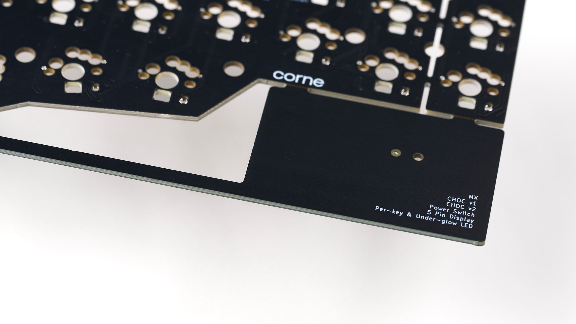 Detail view of Corne v3.6 PCB breakaway tab with printed feature list and corne logo