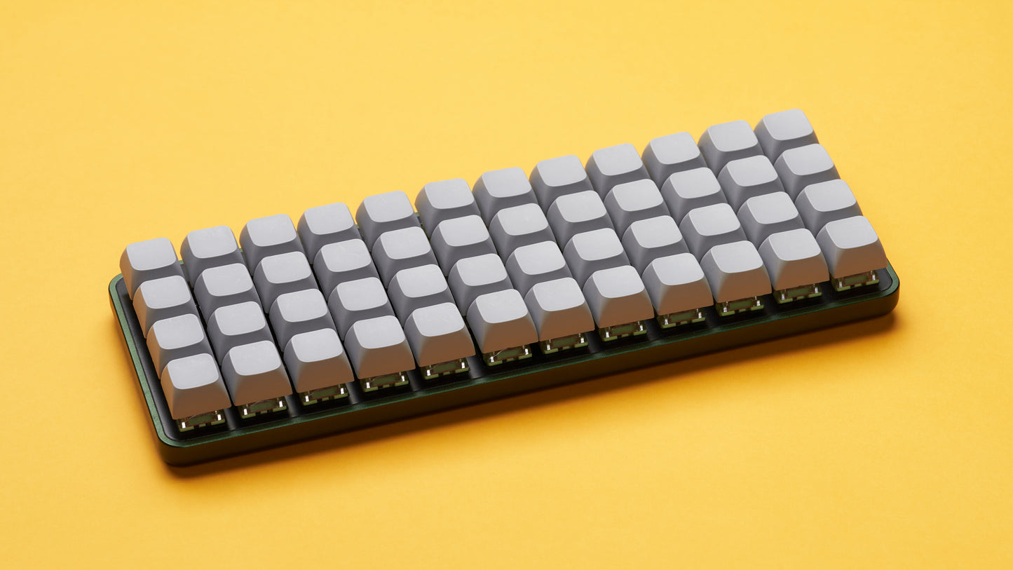Equals 48 ortholinear keyboard on yellow background with grey keycaps