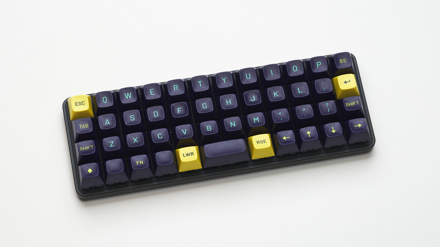 View of Equals 48 from the top down showing dark blue keycaps and bright yellow modifiers on a white background.