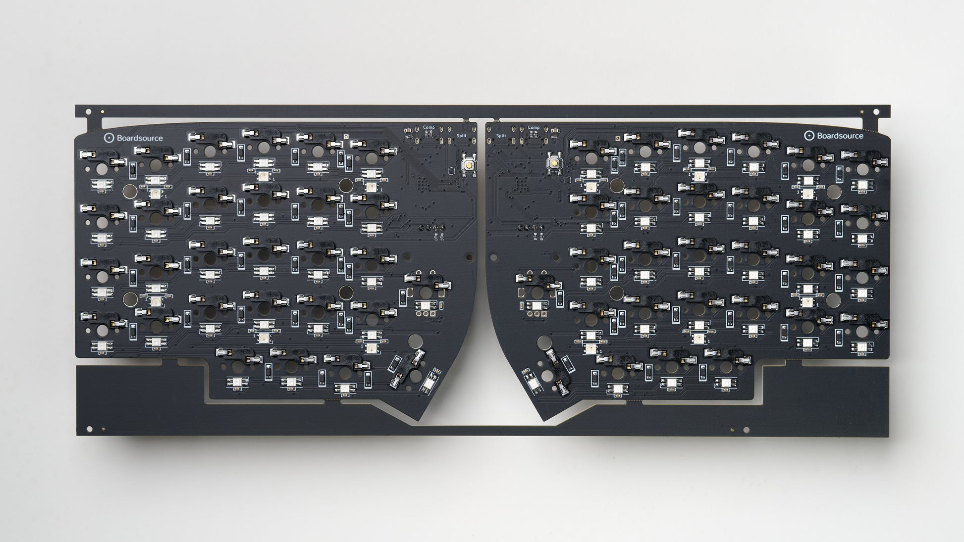 Top-down view of fully assembled Lily58 SMT PCB panel with hotswap sockets, dual USB-C ports, and per-key RGB LEDs on matte black board.