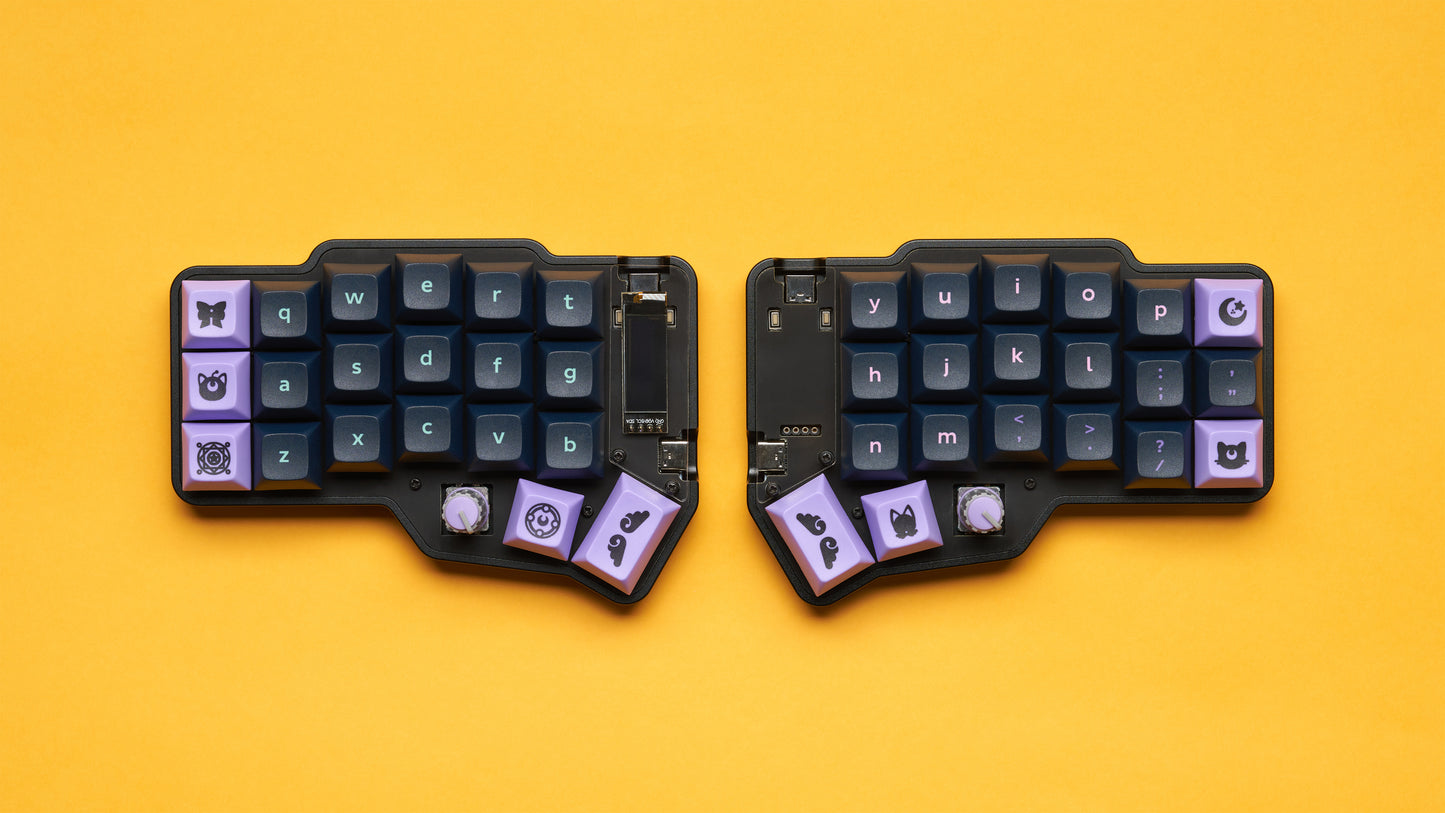 Top-down view of a black Corne keyboard with purple keycaps and joystick modules, built in a Unicorne case.