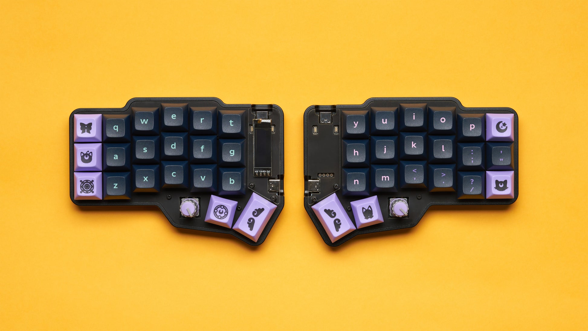 Top-down view of a black Corne keyboard with purple keycaps and joystick modules, built in a Unicorne case.
