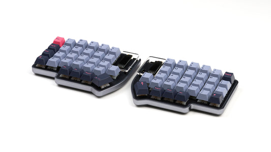 Lily Pad split 60% keyboard with gray case and GMK 8008 keycaps on a white background