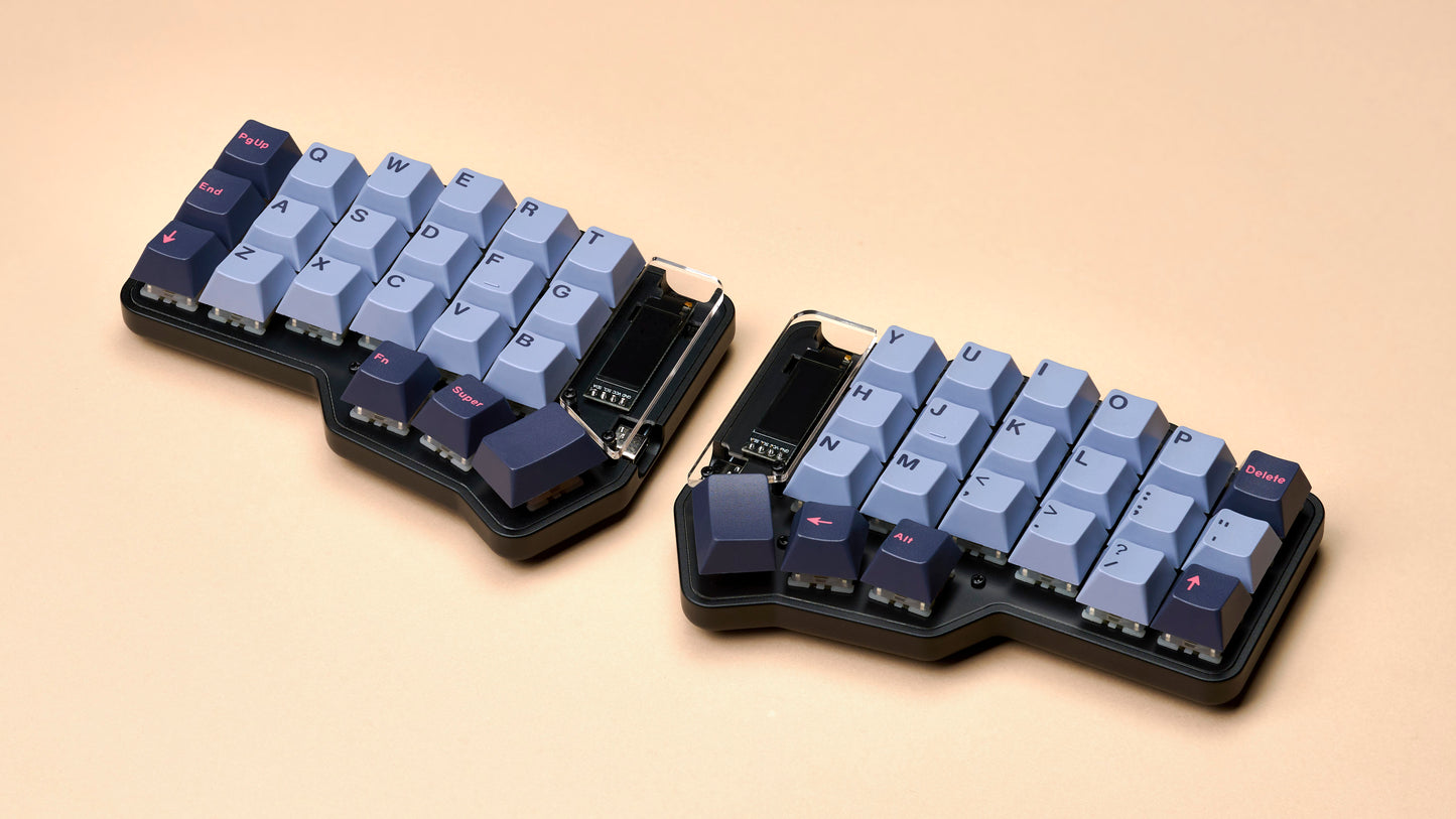 Unicorne split keyboard with GMK 8008 keycaps on a beige background.